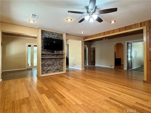 8 Geneva Ln, Chico, CA 95926 - unfurnished living room with ceiling fan, arched walkways, baseboards, and wood finished floors