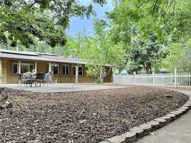 8 Geneva Ln, Chico, CA 95926 - back of property featuring solar panels, stucco siding, and a patio