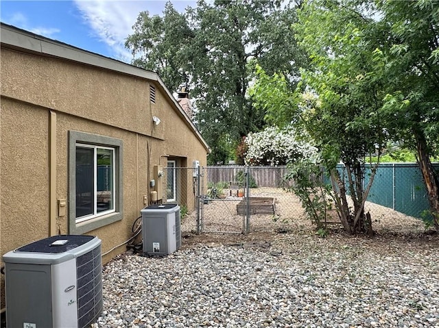 8 Geneva Ln, Chico, CA 95926 - fenced backyard with central AC unit, a gate, and a cooling unit