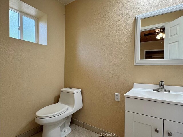 8 Geneva Ln, Chico, CA 95926 - half bathroom featuring vanity, toilet, tile patterned flooring, baseboards, and a ceiling fan