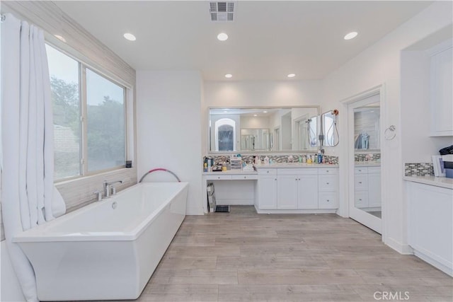 1189 Canyon Glen Rd, Chino Hills, CA 91709 - full bath featuring a freestanding bath, vanity, recessed lighting, tasteful backsplash, and wood finished floors
