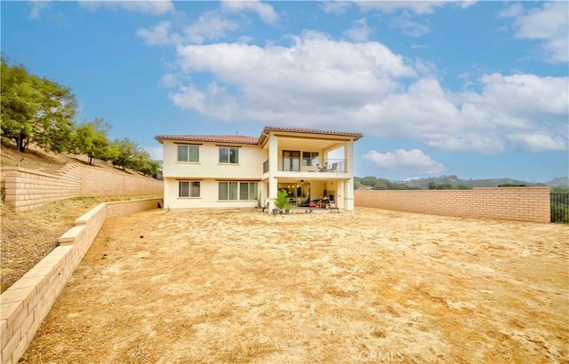 1189 Canyon Glen Rd, Chino Hills, CA 91709 - rear view of house with a tile roof, stucco siding, a balcony, a fenced backyard, and a patio