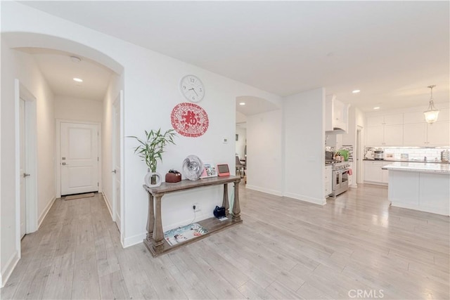 1189 Canyon Glen Rd, Chino Hills, CA 91709 - hall with arched walkways, light wood-style floors, recessed lighting, and baseboards