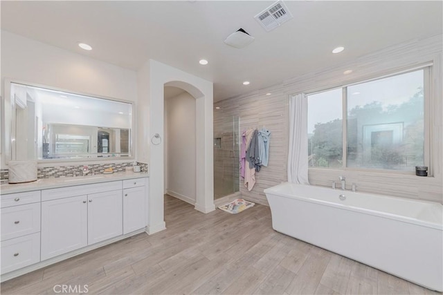 1189 Canyon Glen Rd, Chino Hills, CA 91709 - bathroom featuring a soaking tub, vanity, wood finished floors, recessed lighting, and a shower stall