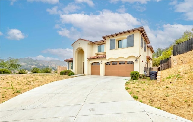 1189 Canyon Glen Rd, Chino Hills, CA 91709 - mediterranean / spanish home featuring a tile roof, driveway, a garage, stucco siding, and a mountain view