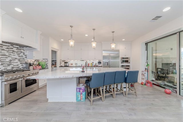 1189 Canyon Glen Rd, Chino Hills, CA 91709 - kitchen featuring appliances with stainless steel finishes, recessed lighting, white cabinets, light countertops, and light wood-style flooring
