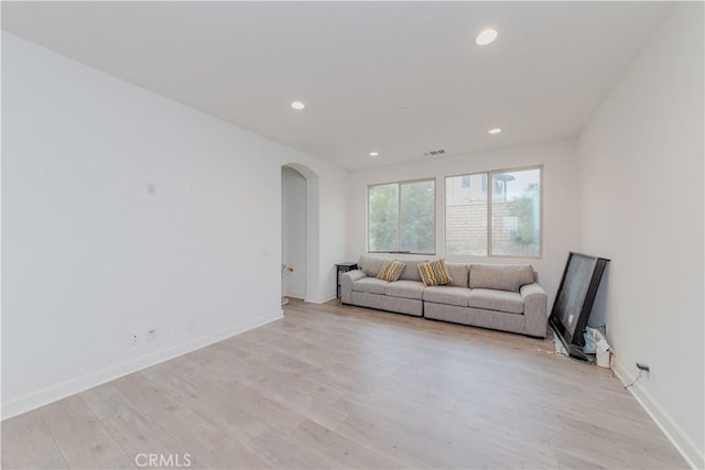 1189 Canyon Glen Rd, Chino Hills, CA 91709 - living area featuring arched walkways, light wood-style flooring, recessed lighting, and baseboards