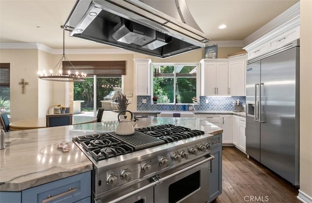 31201 Old San Juan Rd, San Juan Capistrano, CA 92675 - kitchen featuring premium appliances, wall chimney exhaust hood, ornamental molding, a chandelier, and white cabinetry