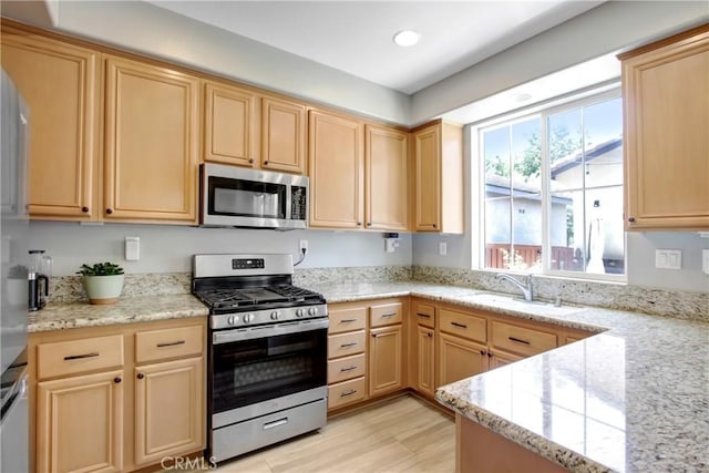 4533 Filson St, Riverside, CA 92507 - kitchen with stainless steel appliances, light brown cabinetry, a sink, recessed lighting, and light wood-style flooring