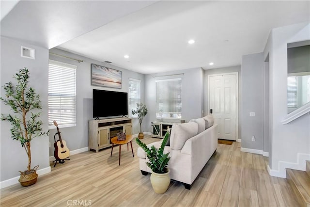 4533 Filson St, Riverside, CA 92507 - living room with light wood finished floors, baseboards, plenty of natural light, recessed lighting, and stairs