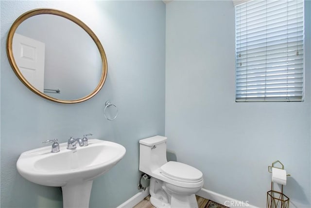 4533 Filson St, Riverside, CA 92507 - half bathroom featuring baseboards, toilet, and a sink
