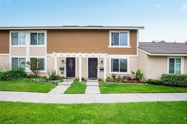 3021 S Sycamore St Unit D, Santa Ana, CA 92707 - view of front facade with a pergola, a front yard, and stucco siding