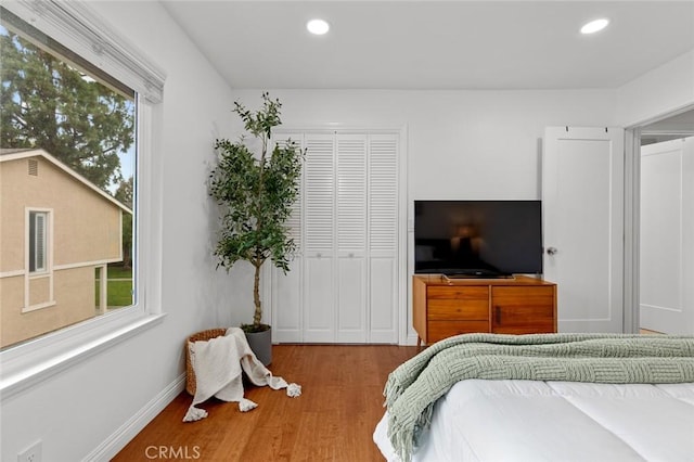 3021 S Sycamore St Unit D, Santa Ana, CA 92707 - bedroom featuring wood finished floors, multiple windows, recessed lighting, and a closet