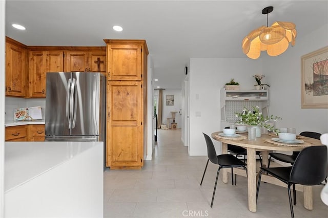 3021 S Sycamore St Unit D, Santa Ana, CA 92707 - kitchen with freestanding refrigerator, brown cabinets, light countertops, recessed lighting, and light tile patterned floors