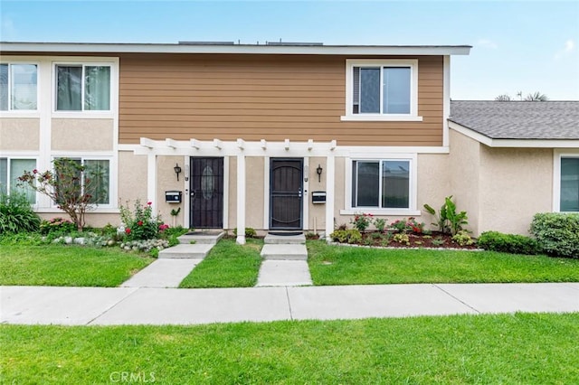 3021 S Sycamore St Unit D, Santa Ana, CA 92707 - view of front of home with a pergola, a front lawn, and stucco siding