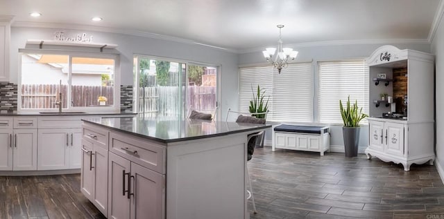 1242 Pleasant Hill St, Escondido, CA 92026 - kitchen featuring a sink, dark wood-style floors, a chandelier, backsplash, and ornamental molding