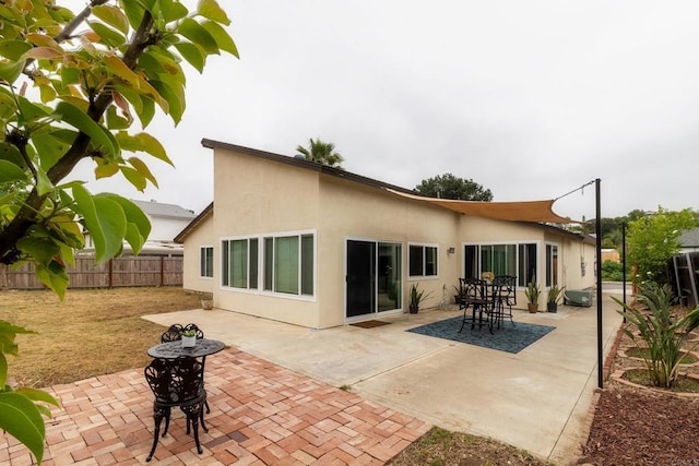 1242 Pleasant Hill St, Escondido, CA 92026 - back of property with a fenced backyard, stucco siding, and a patio area