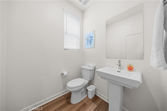 8254 Traveller St, Chino, CA 91708 - bathroom with baseboards, toilet, and wood finished floors