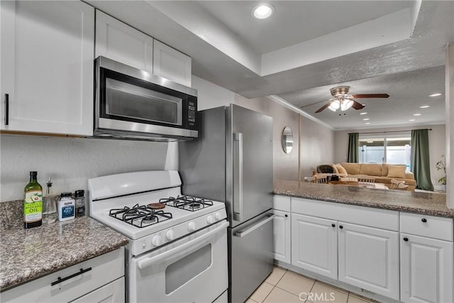 744 W Lambert Rd Unit 51, La Habra, CA 90631 - kitchen with white gas stove, stainless steel microwave, white cabinetry, crown molding, and recessed lighting