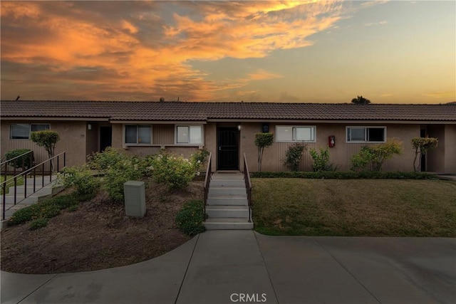 744 W Lambert Rd Unit 51, La Habra, CA 90631 - view of front facade featuring stucco siding, a tile roof, and stairs