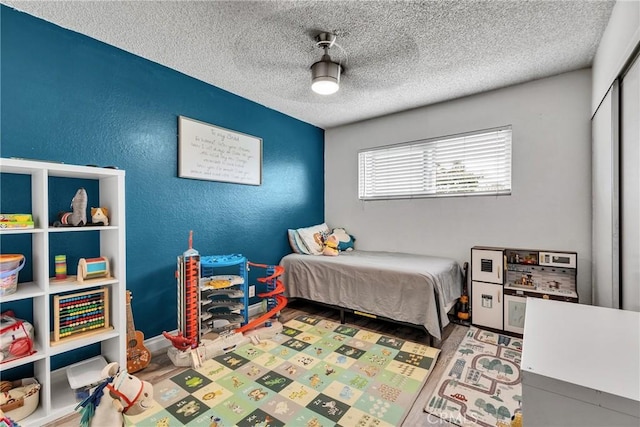 744 W Lambert Rd Unit 51, La Habra, CA 90631 - bedroom featuring a textured ceiling, a closet, a ceiling fan, and a textured wall
