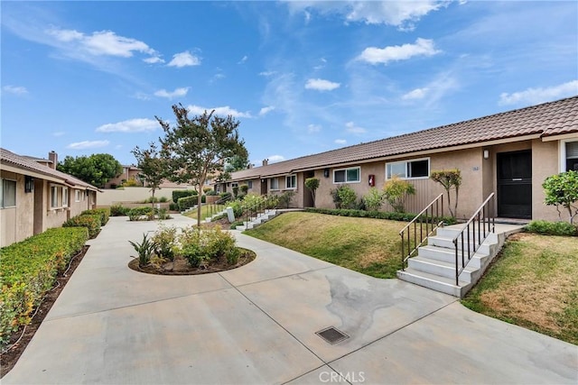 744 W Lambert Rd Unit 51, La Habra, CA 90631 - view of front of home featuring stucco siding, a front yard, and a tiled roof