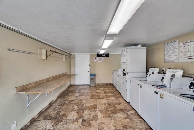 744 W Lambert Rd Unit 51, La Habra, CA 90631 - shared laundry room with washing machine and clothes dryer, stacked washer / dryer, stone finish floors, and a textured ceiling
