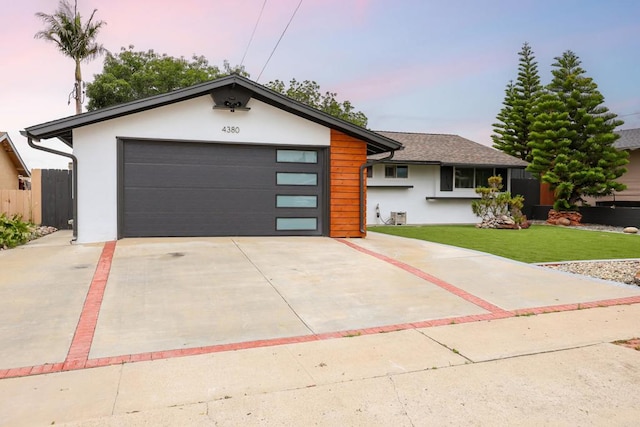 4380 Rolfe Rd, San Diego, CA 92117 - view of front facade featuring stucco siding, concrete driveway, a yard, and an attached garage