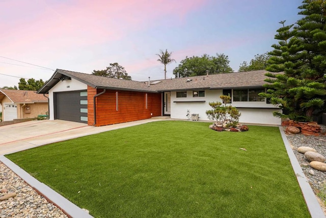 4380 Rolfe Rd, San Diego, CA 92117 - view of front of house with an attached garage, concrete driveway, a front lawn, and stucco siding