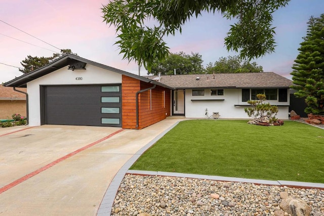 4380 Rolfe Rd, San Diego, CA 92117 - view of front of house with stucco siding, driveway, a garage, and a lawn