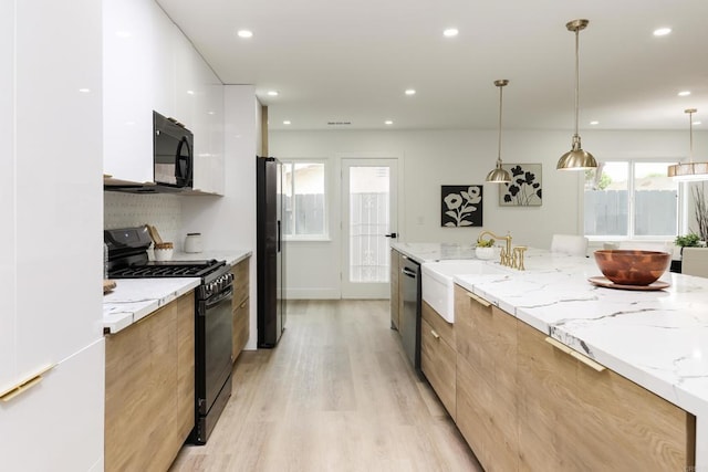 4380 Rolfe Rd, San Diego, CA 92117 - kitchen featuring modern cabinets, black appliances, light wood-style floors, white cabinets, and a sink