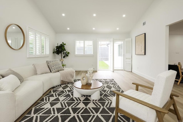 4380 Rolfe Rd, San Diego, CA 92117 - living area featuring light wood finished floors, recessed lighting, baseboards, and high vaulted ceiling