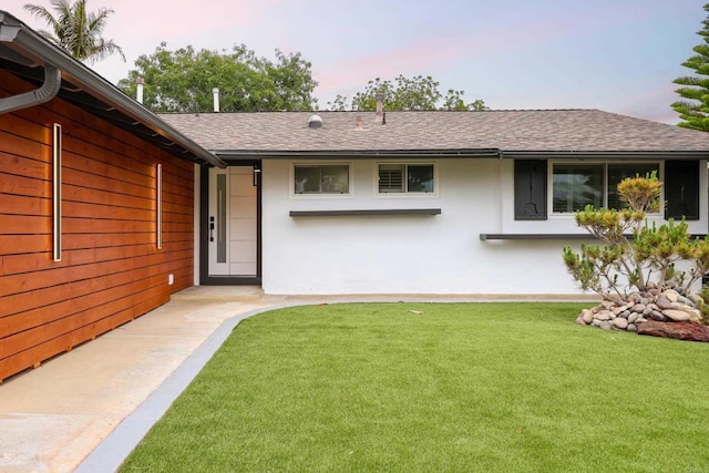4380 Rolfe Rd, San Diego, CA 92117 - back of property with stucco siding, a shingled roof, and a lawn