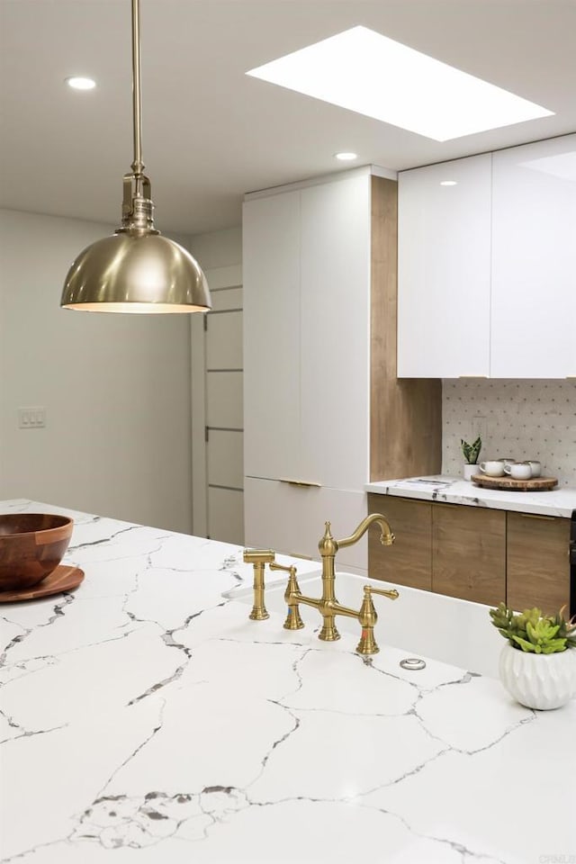 4380 Rolfe Rd, San Diego, CA 92117 - kitchen with modern cabinets, white cabinetry, light stone counters, decorative light fixtures, and recessed lighting