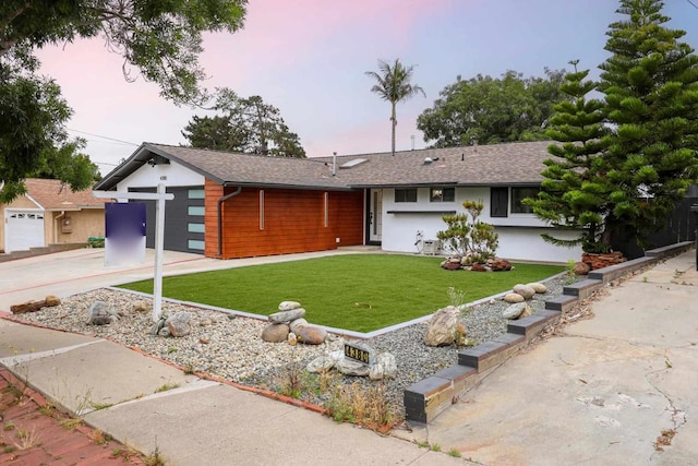 4380 Rolfe Rd, San Diego, CA 92117 - view of front of home with a front yard, driveway, an attached garage, and stucco siding