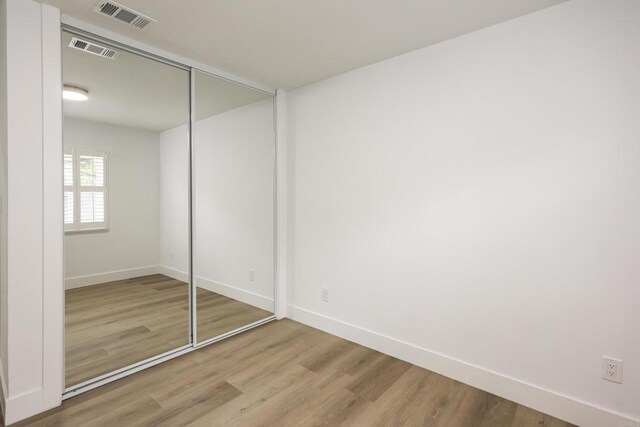 4380 Rolfe Rd, San Diego, CA 92117 - unfurnished bedroom featuring baseboards, wood finished floors, and a closet