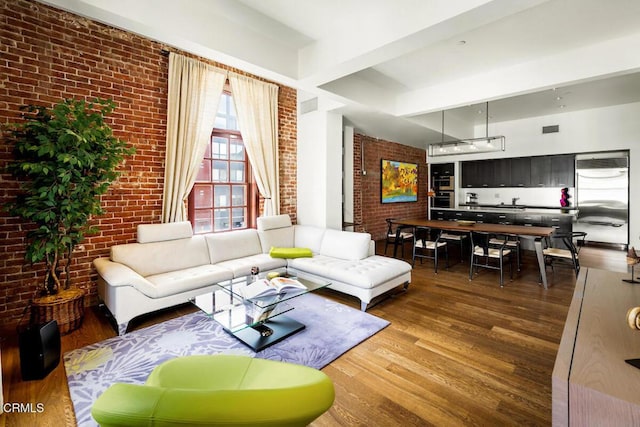 940 E 2nd St Unit 37, Los Angeles, CA 90012 - living area featuring brick wall and wood finished floors