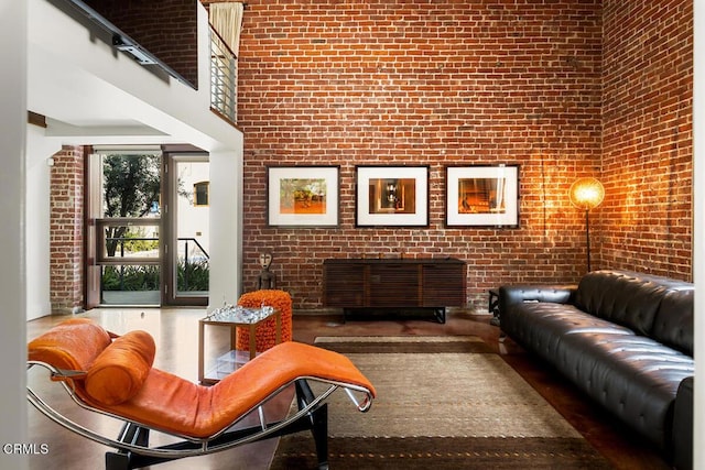 940 E 2nd St Unit 37, Los Angeles, CA 90012 - living area featuring brick wall and a high ceiling