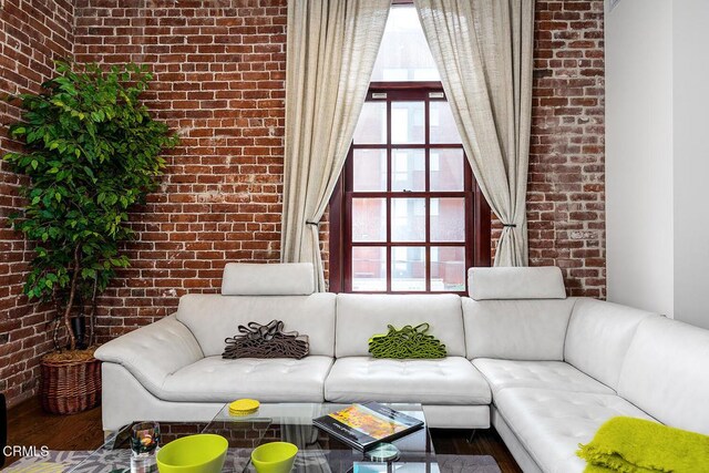 940 E 2nd St Unit 37, Los Angeles, CA 90012 - living area with brick wall and wood finished floors
