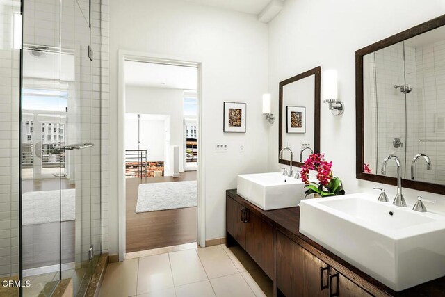 940 E 2nd St Unit 37, Los Angeles, CA 90012 - full bathroom featuring double vanity, a stall shower, and tile patterned floors