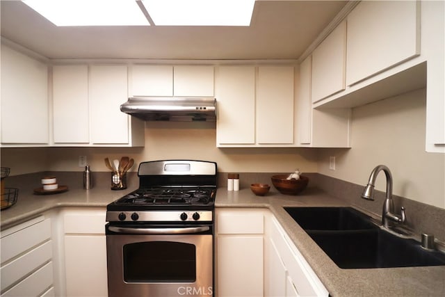 430 N Holliston Ave Unit 210, Pasadena, CA 91106 - kitchen with stainless steel range with gas cooktop, under cabinet range hood, a sink, and white cabinetry