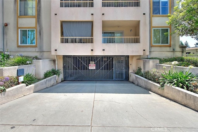 430 N Holliston Ave Unit 210, Pasadena, CA 91106 - view of building exterior featuring driveway and a garage