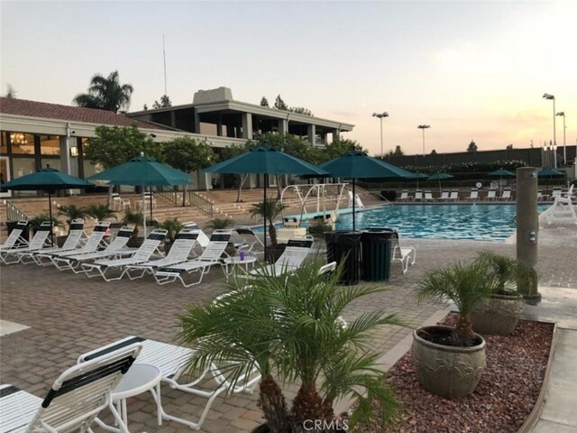 22702 Islamare Ln, Lake Forest, CA 92630 - pool at dusk with a community pool and a patio area