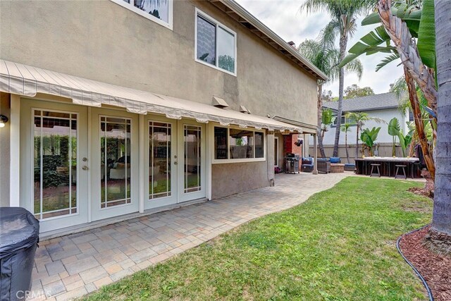 22702 Islamare Ln, Lake Forest, CA 92630 - rear view of property featuring french doors, a patio, stucco siding, and a jacuzzi