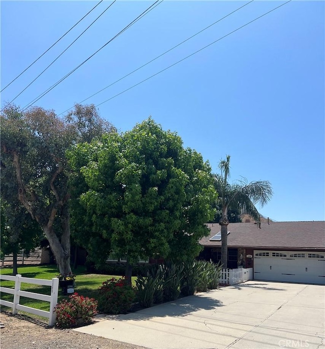 1390 Corona Ave, Norco, CA 92860 - obstructed view of property featuring driveway and a garage