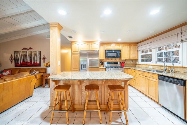 1390 Corona Ave, Norco, CA 92860 - kitchen with appliances with stainless steel finishes, light tile patterned flooring, open floor plan, a breakfast bar area, and light stone counters