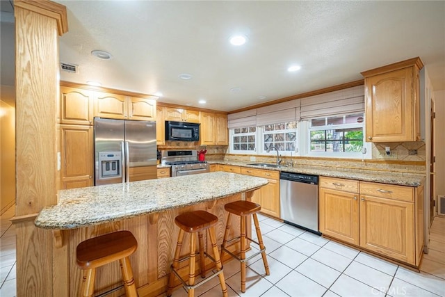 1390 Corona Ave, Norco, CA 92860 - kitchen with stainless steel appliances, decorative backsplash, a breakfast bar area, light stone countertops, and light tile patterned floors