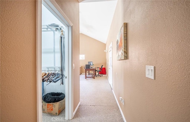 1390 Corona Ave, Norco, CA 92860 - corridor with a textured wall, light carpet, lofted ceiling, and a desk