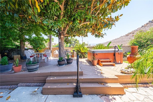 1390 Corona Ave, Norco, CA 92860 - wooden terrace featuring a hot tub, a fenced backyard, outdoor dining space, and a mountain view