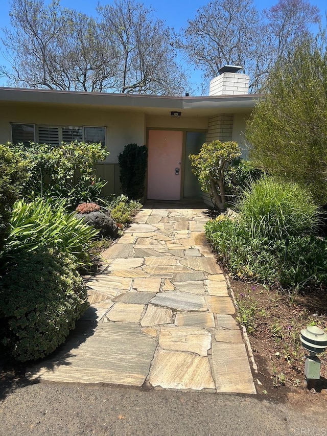 1901 Esplendido Ave, Vista, CA 92084 - property entrance with stucco siding and a chimney